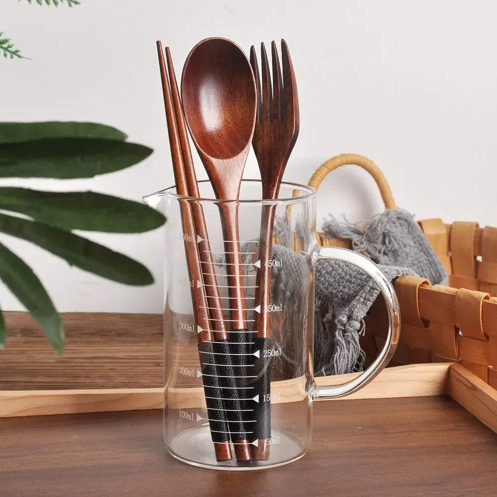 Zen Elegance cutlery in a wooden holder on a dining table – kitchen gift idea